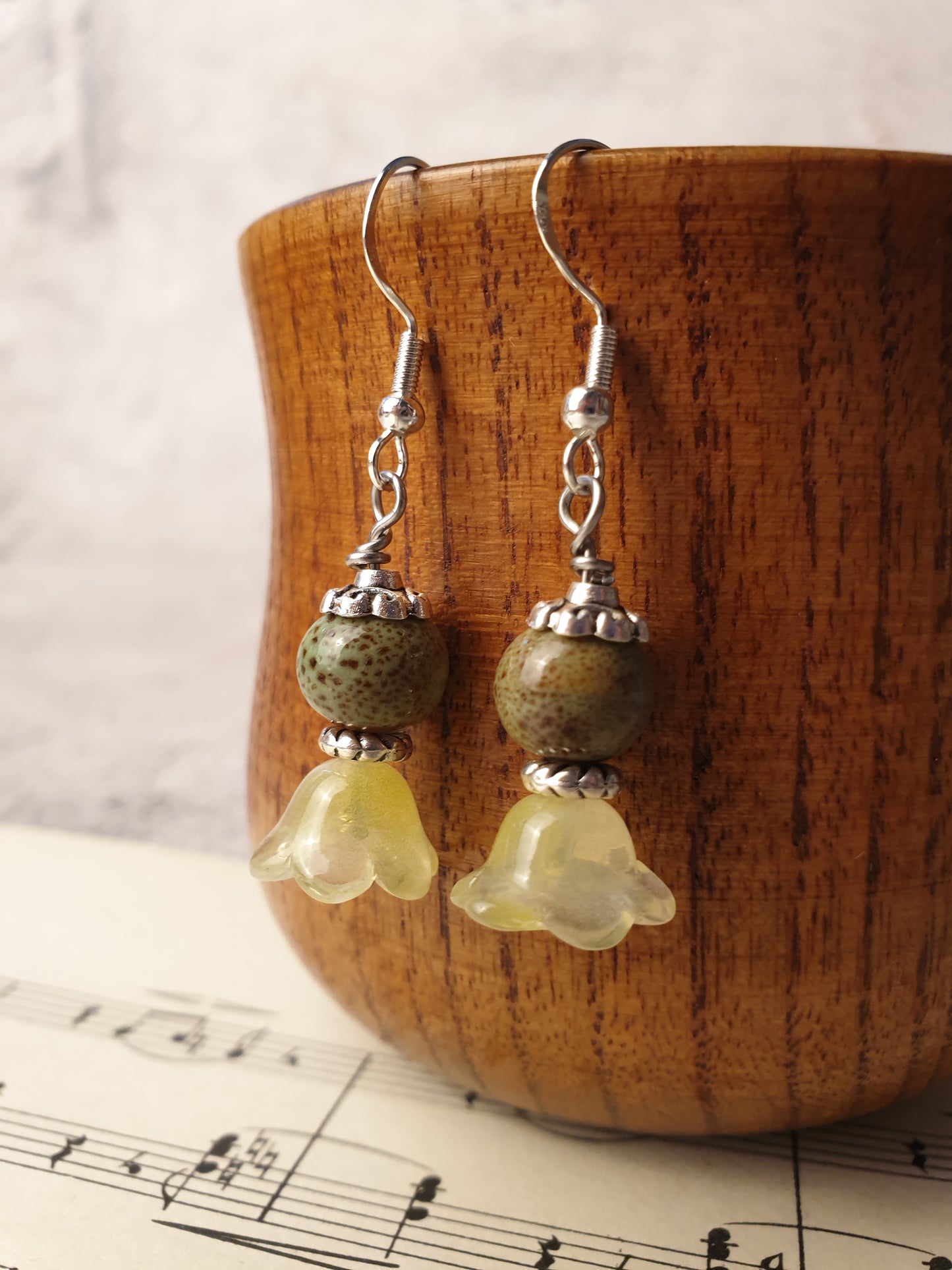 Ceramic bead and glass flower dangle earrings