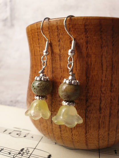 Ceramic bead and glass flower dangle earrings