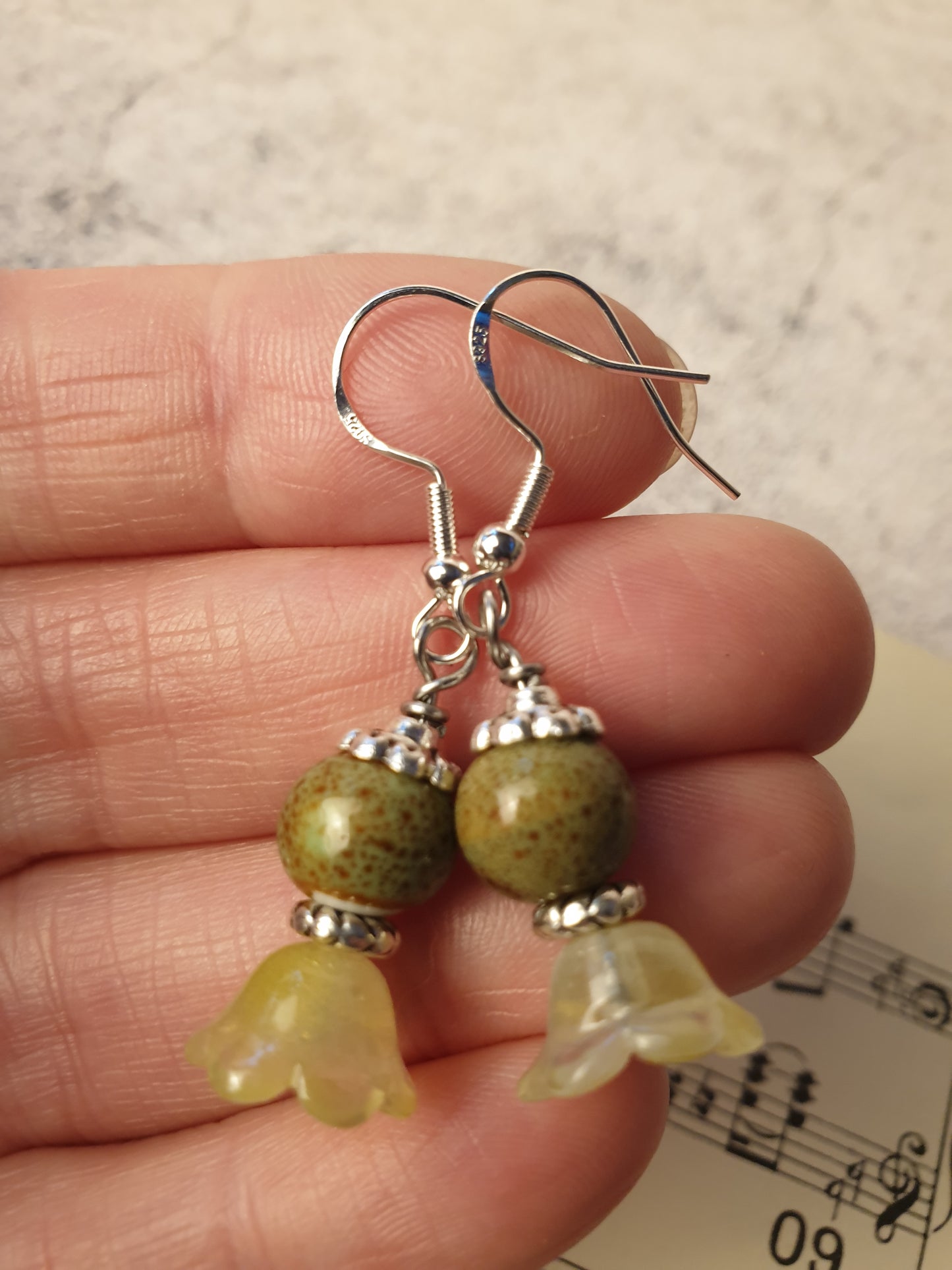 Ceramic bead and glass flower dangle earrings