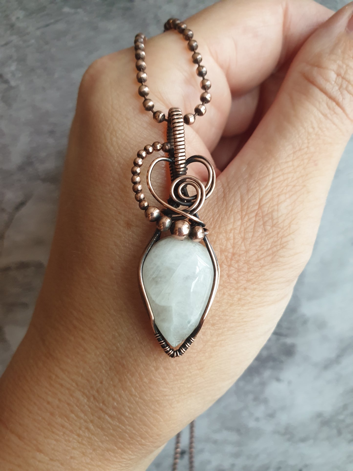 White moonstone gemstone pendant in antiqued copper