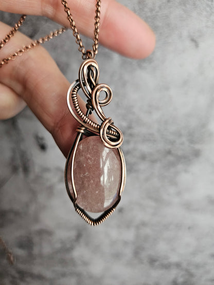 Wire wrapped strawberry quartz pendant