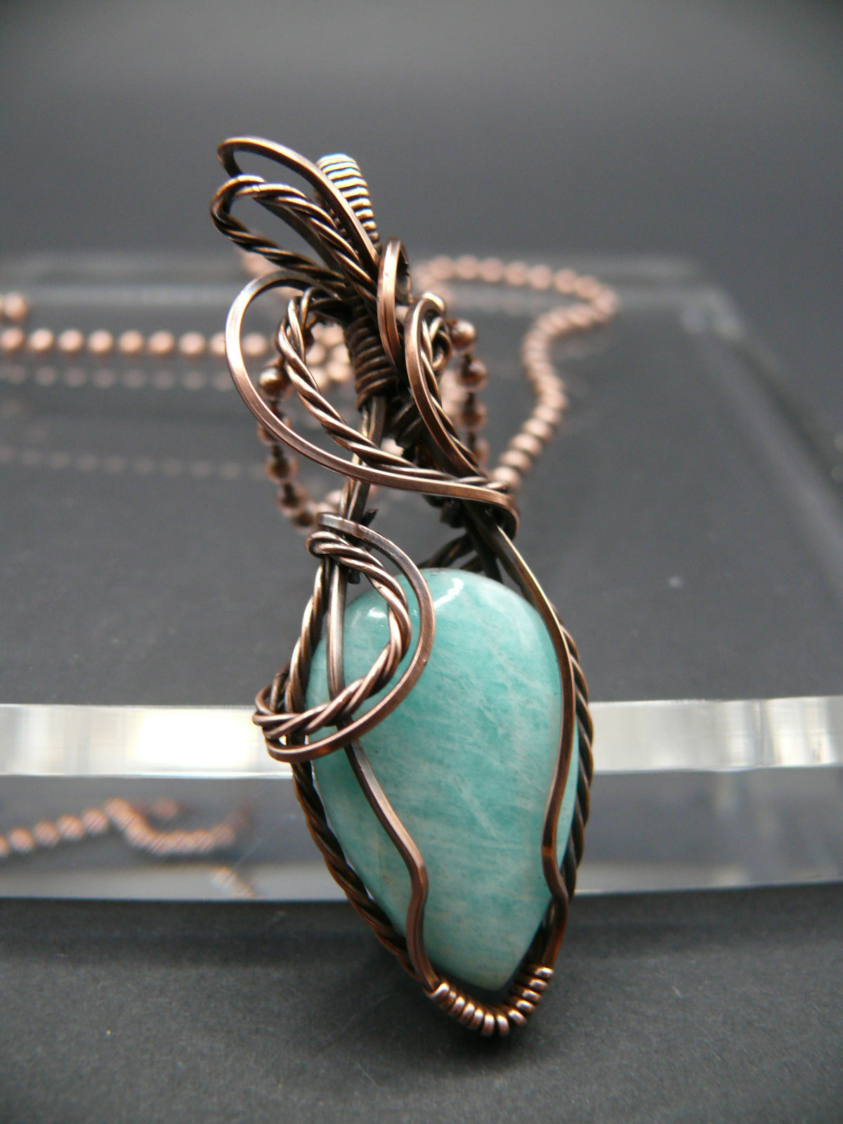 Copper wire wrapped amazonite pendant.