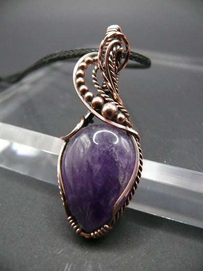 Amethyst gemstone pendant wrapped in antiqued copper