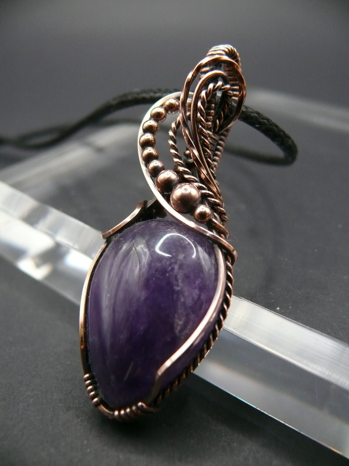 Amethyst gemstone pendant wrapped in antiqued copper