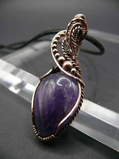 Amethyst gemstone pendant wrapped in antiqued copper