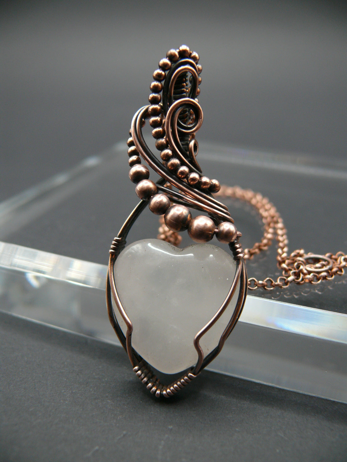 Copper wire-wrapped heart shaped pink rose quartz pendant