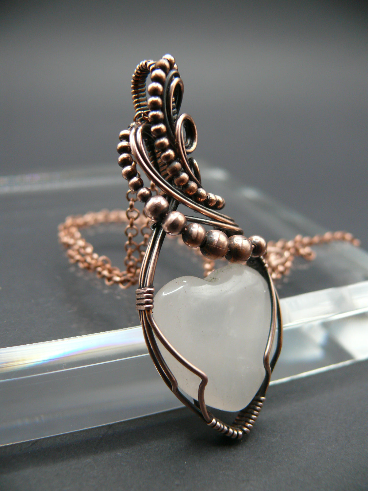 Copper wire-wrapped heart shaped pink rose quartz pendant