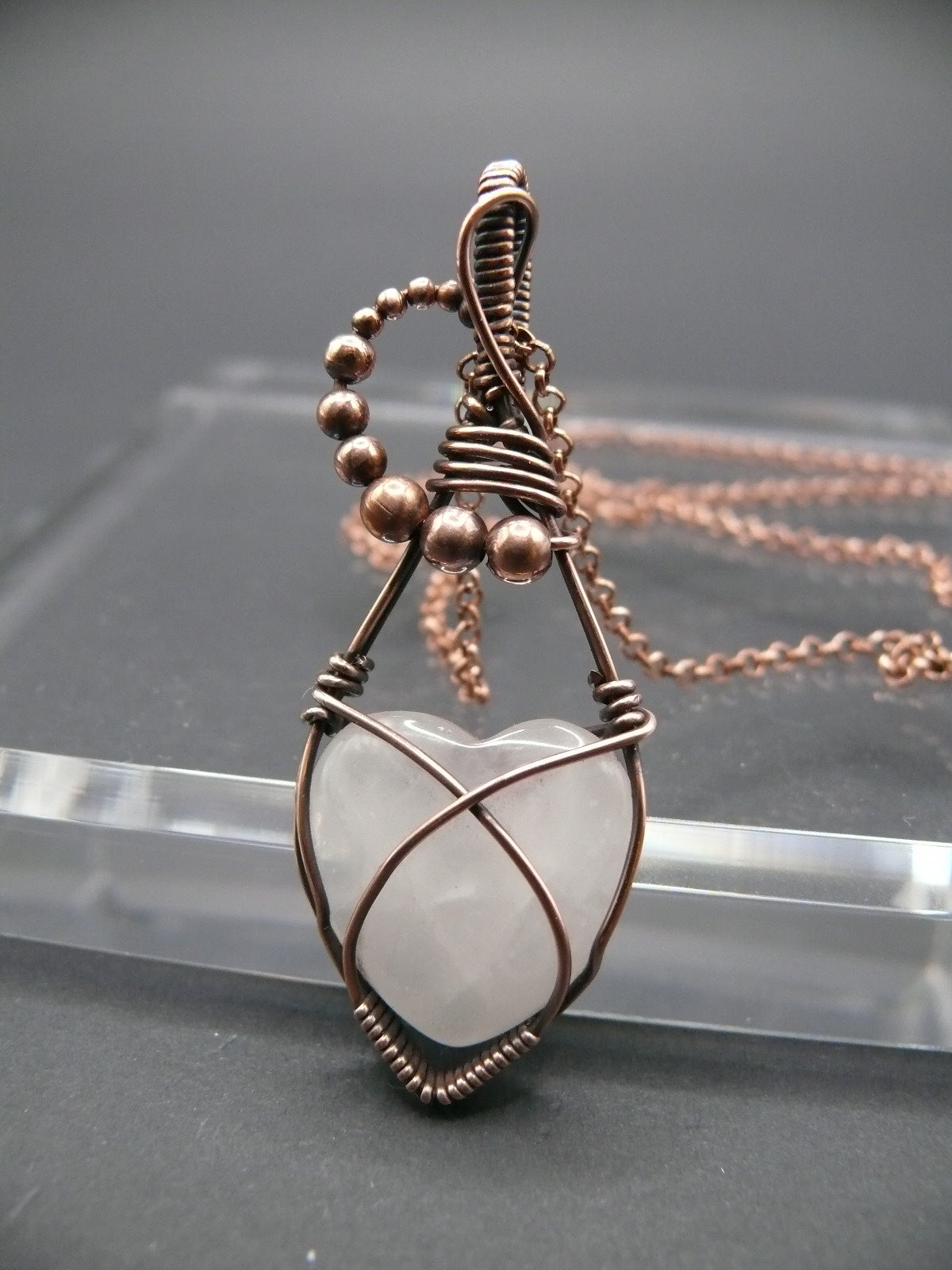 Copper wire-wrapped heart shaped pink rose quartz pendant