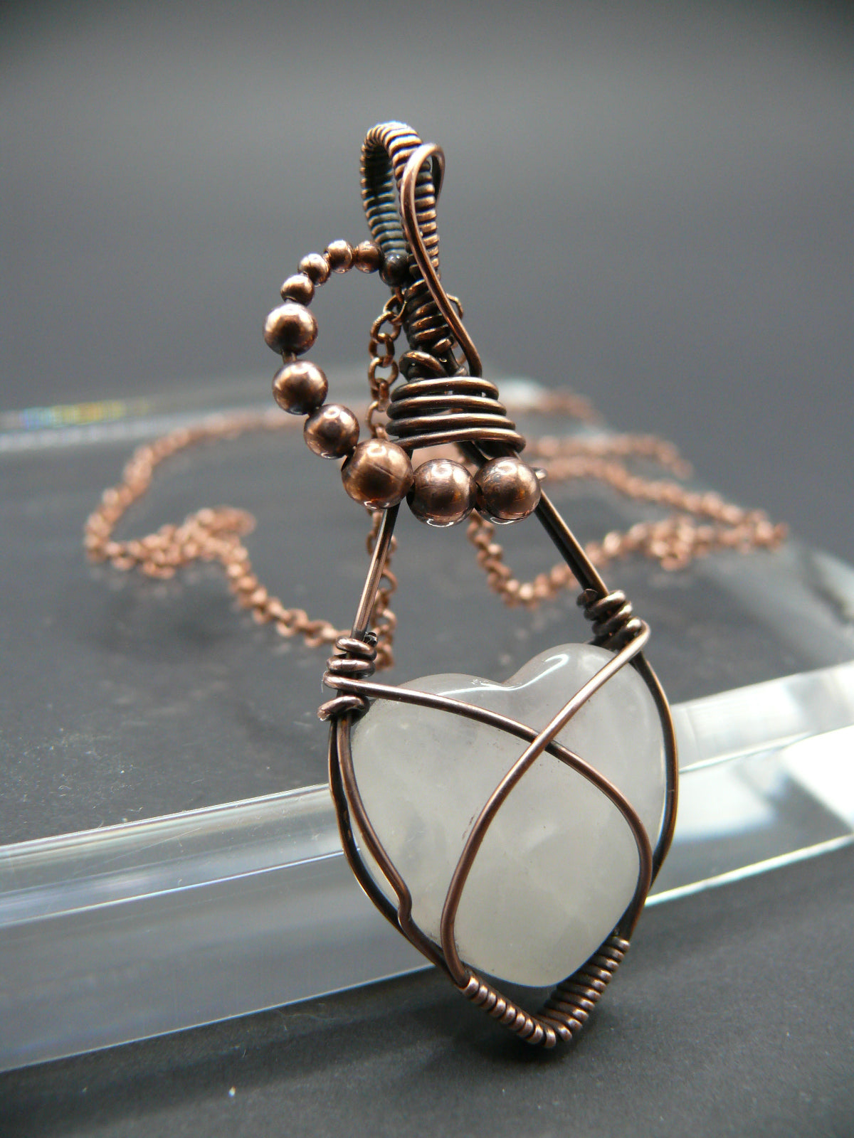 Copper wire-wrapped heart shaped pink rose quartz pendant