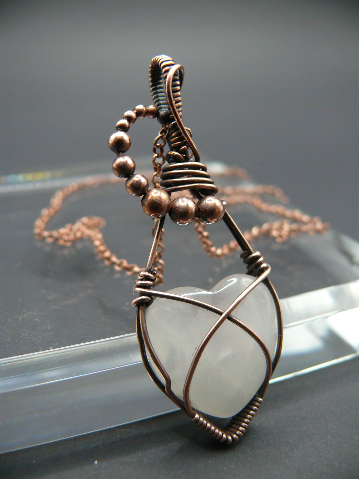 Copper wire-wrapped heart shaped pink rose quartz pendant