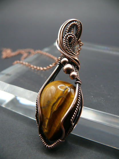 Tiger eye gemstone pendant wrapped in antiqued copper