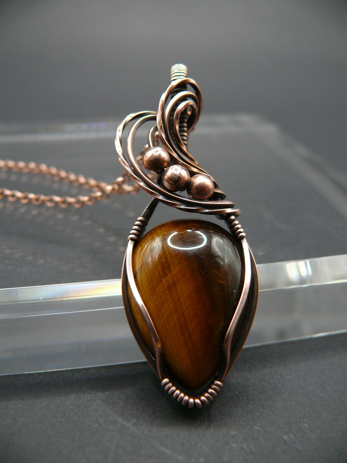 Artisan crafted tiger eye pendant wrapper in copper wire