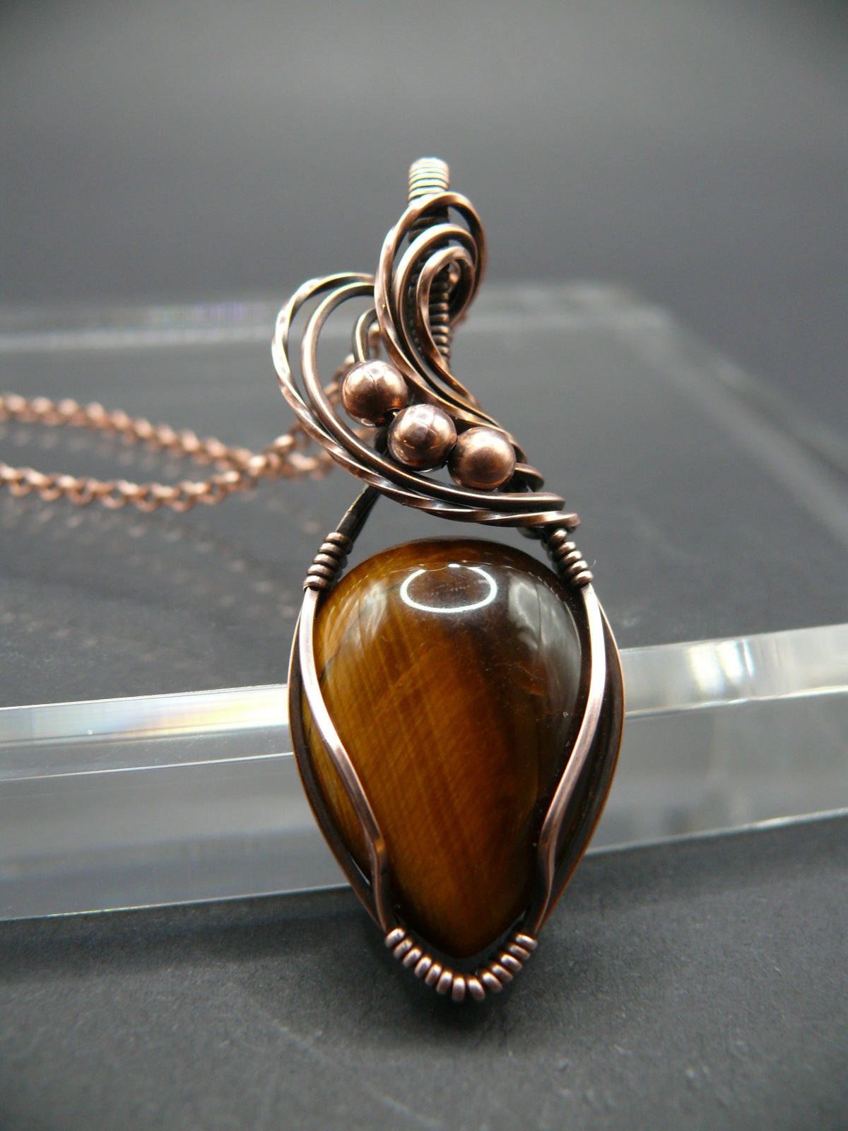 Artisan crafted tiger eye pendant wrapper in copper wire