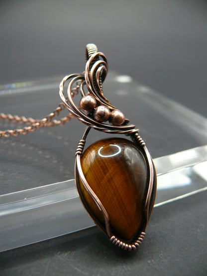 Artisan crafted tiger eye pendant wrapper in copper wire