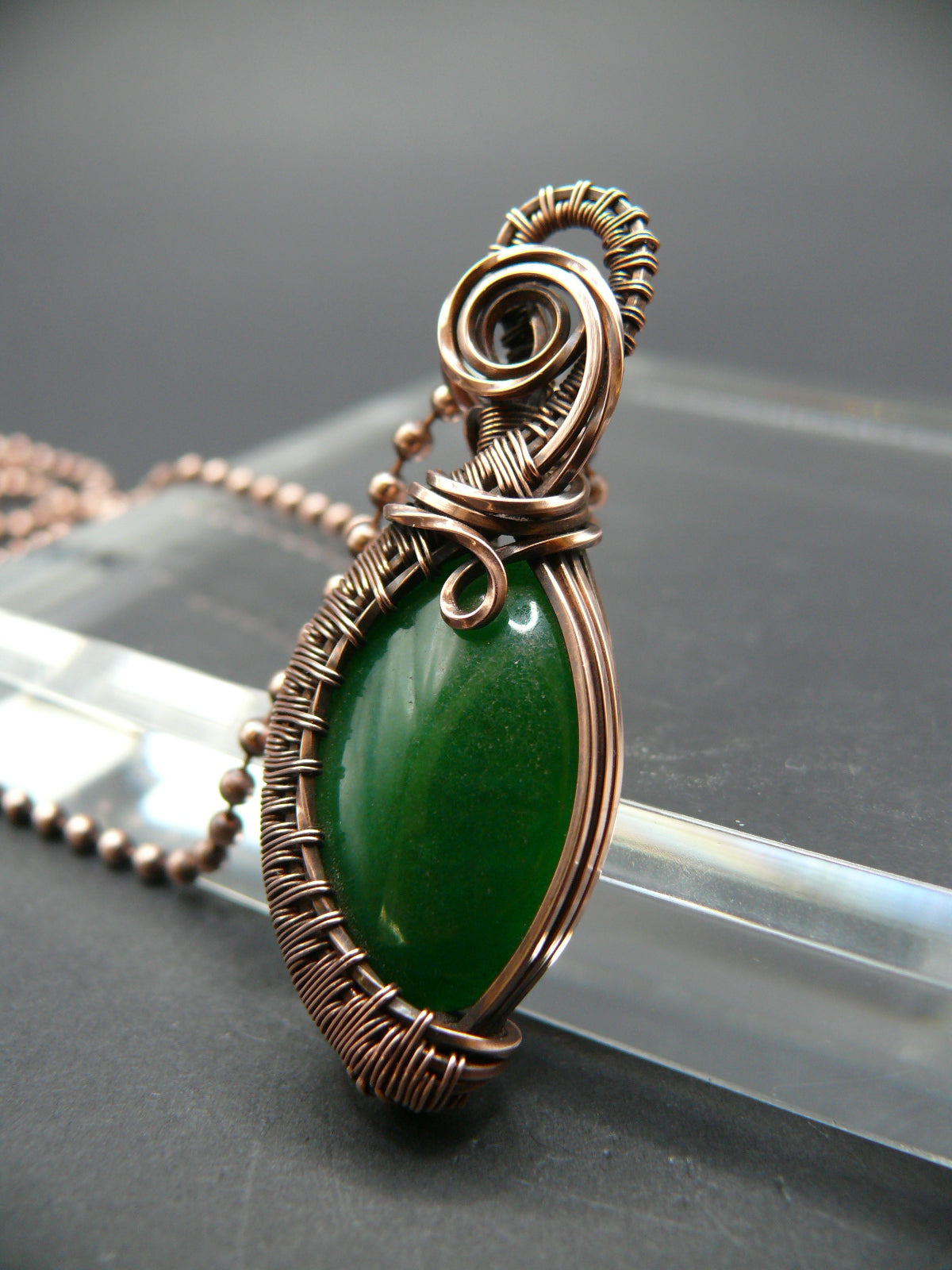 Copper wire weaved green jade pendant