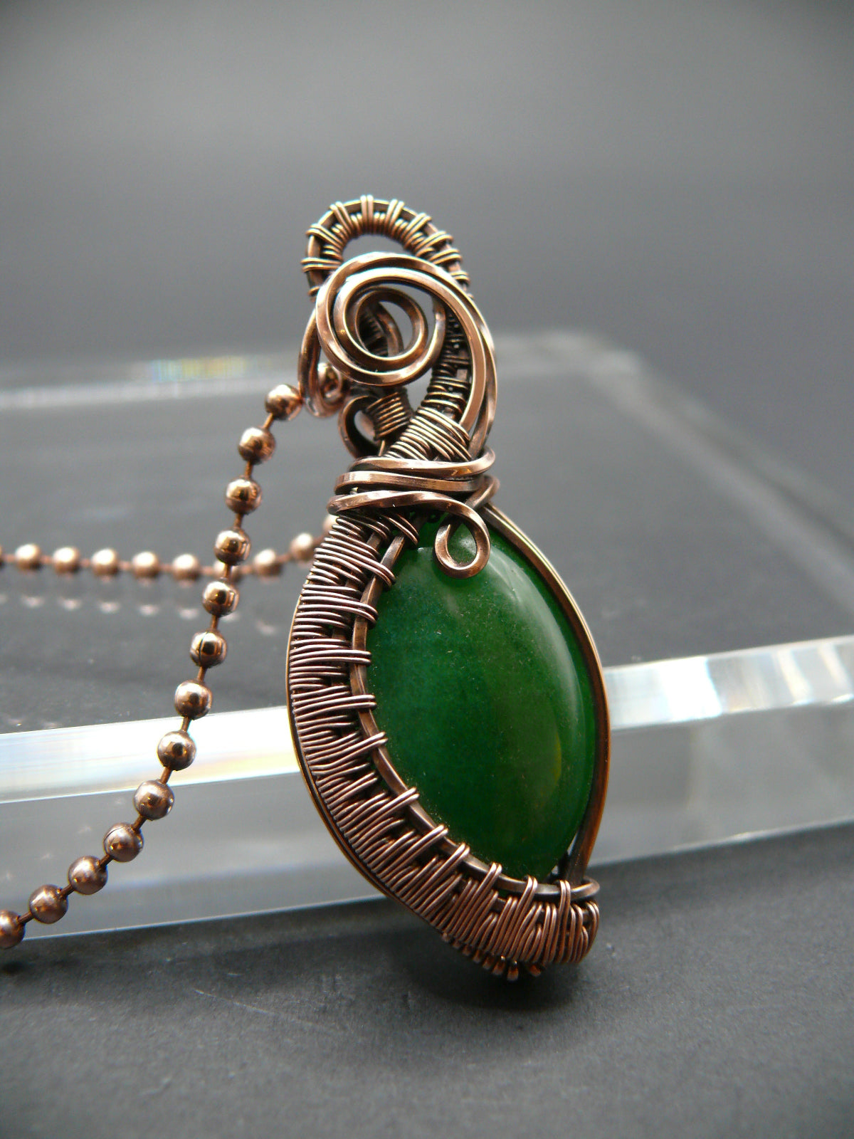 Copper wire weaved green jade pendant