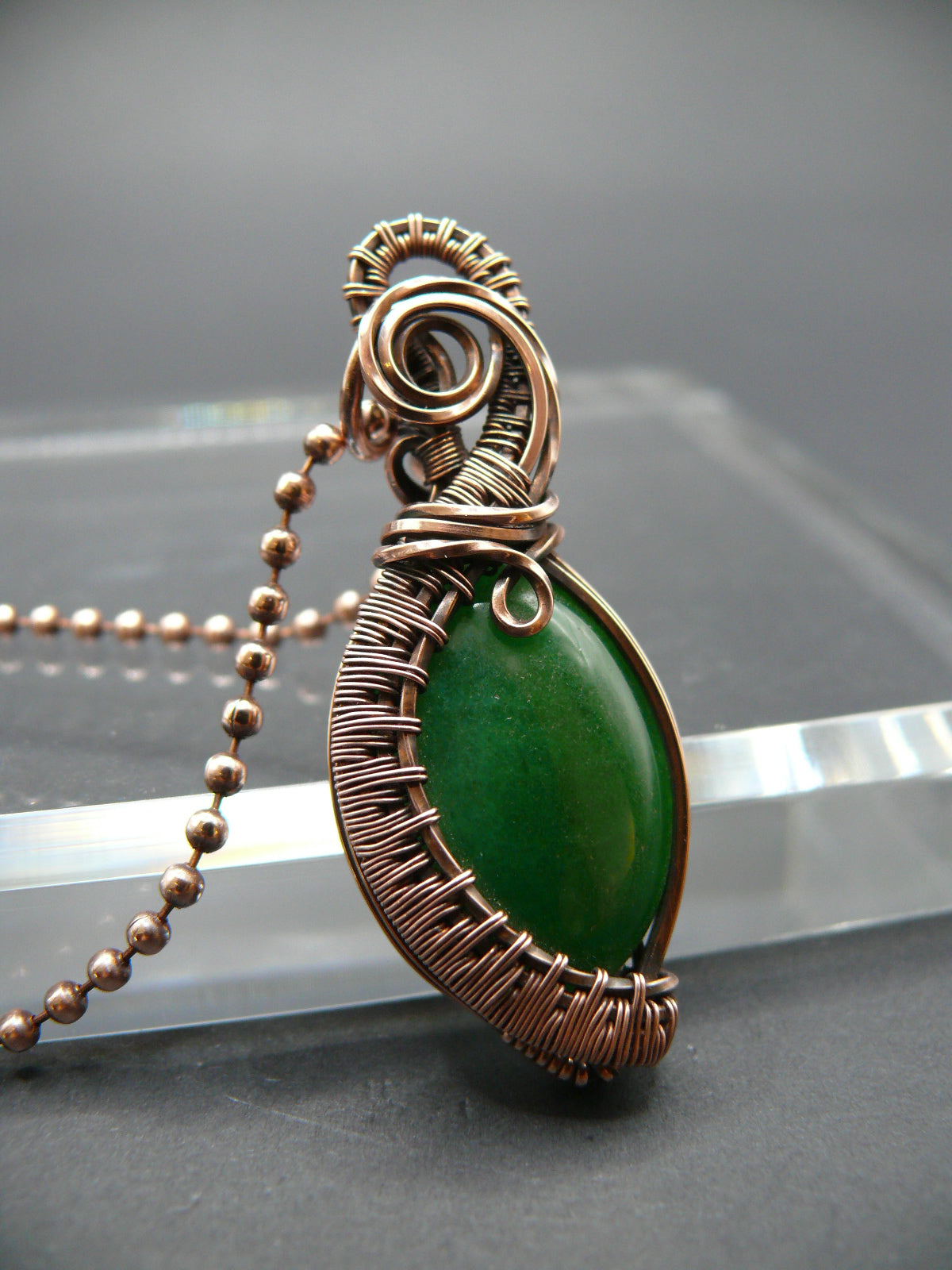 Copper wire weaved green jade pendant