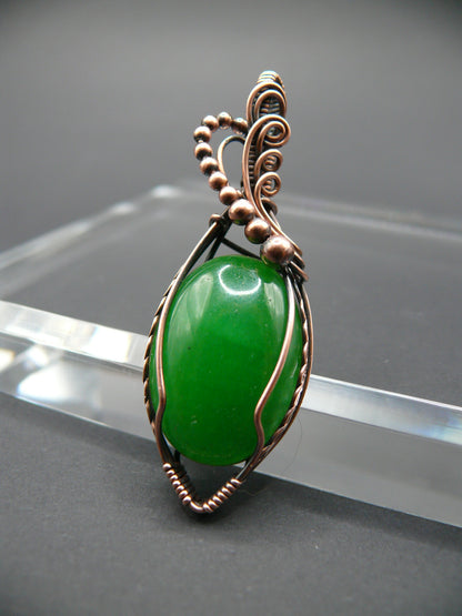 Copper-wrapped jade gemstone pendant