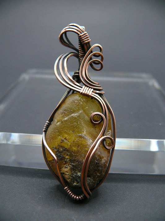 Copper wire wrapped raw Baltic amber pendant