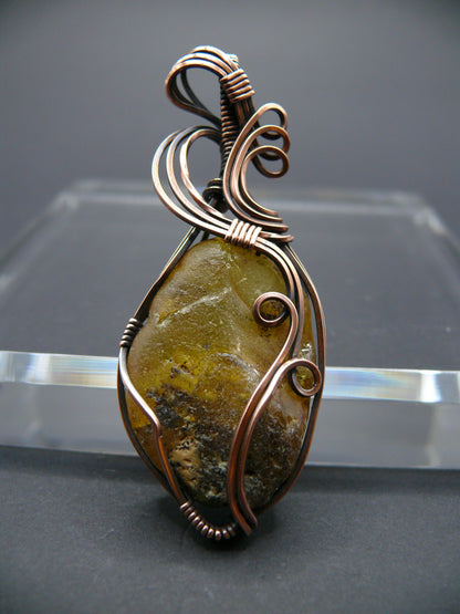 Copper wire wrapped raw Baltic amber pendant