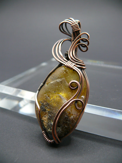 Copper wire wrapped raw Baltic amber pendant