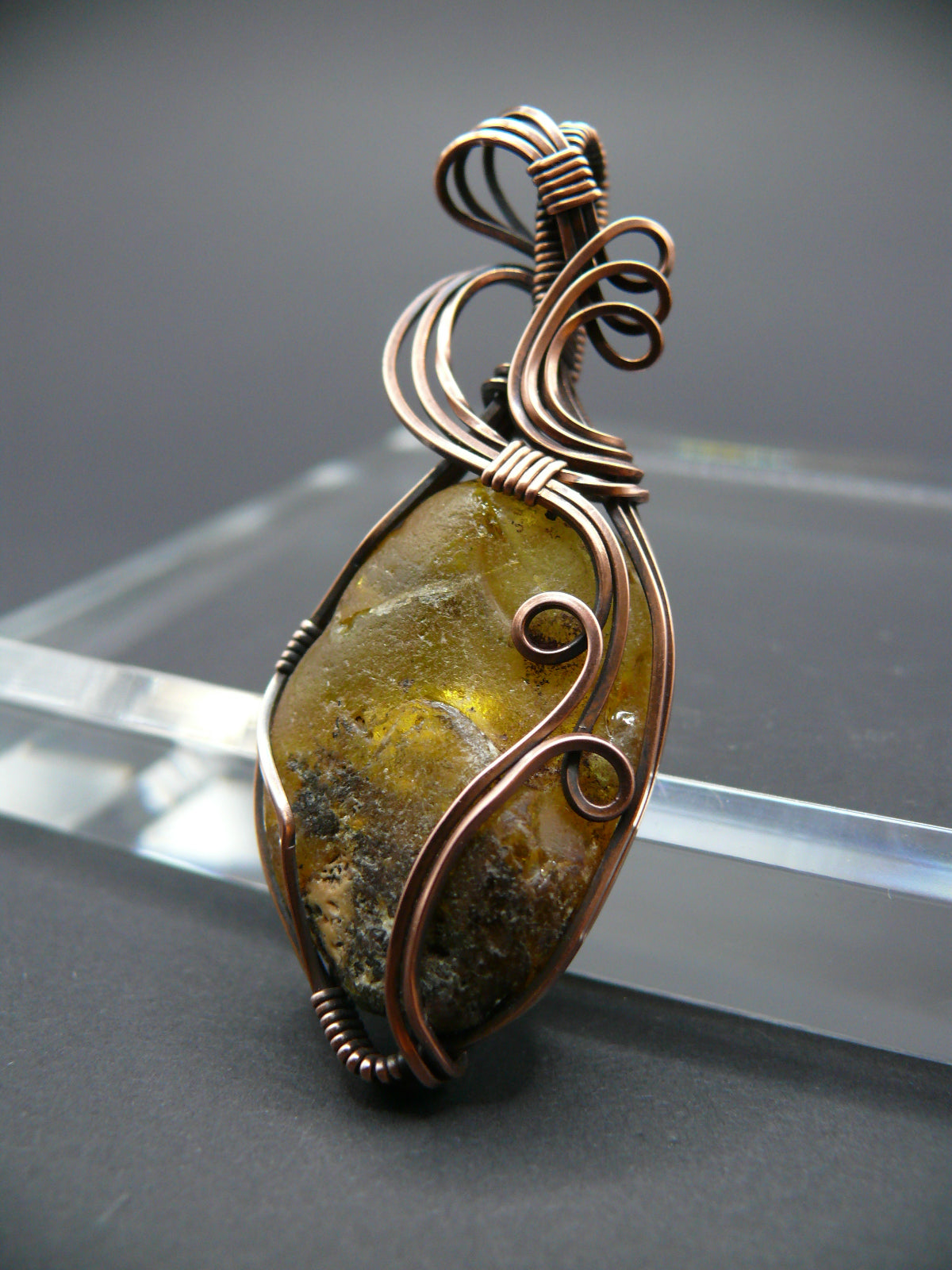 Copper wire wrapped raw Baltic amber pendant