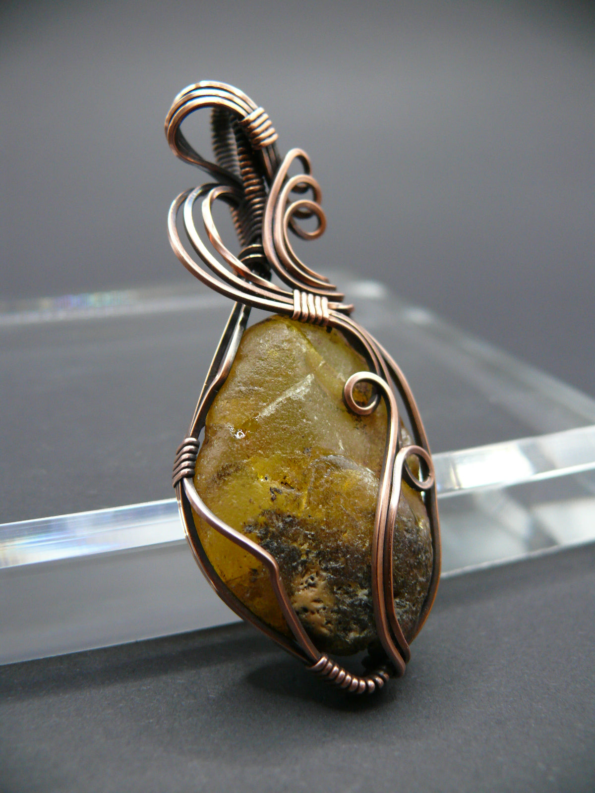 Copper wire wrapped raw Baltic amber pendant