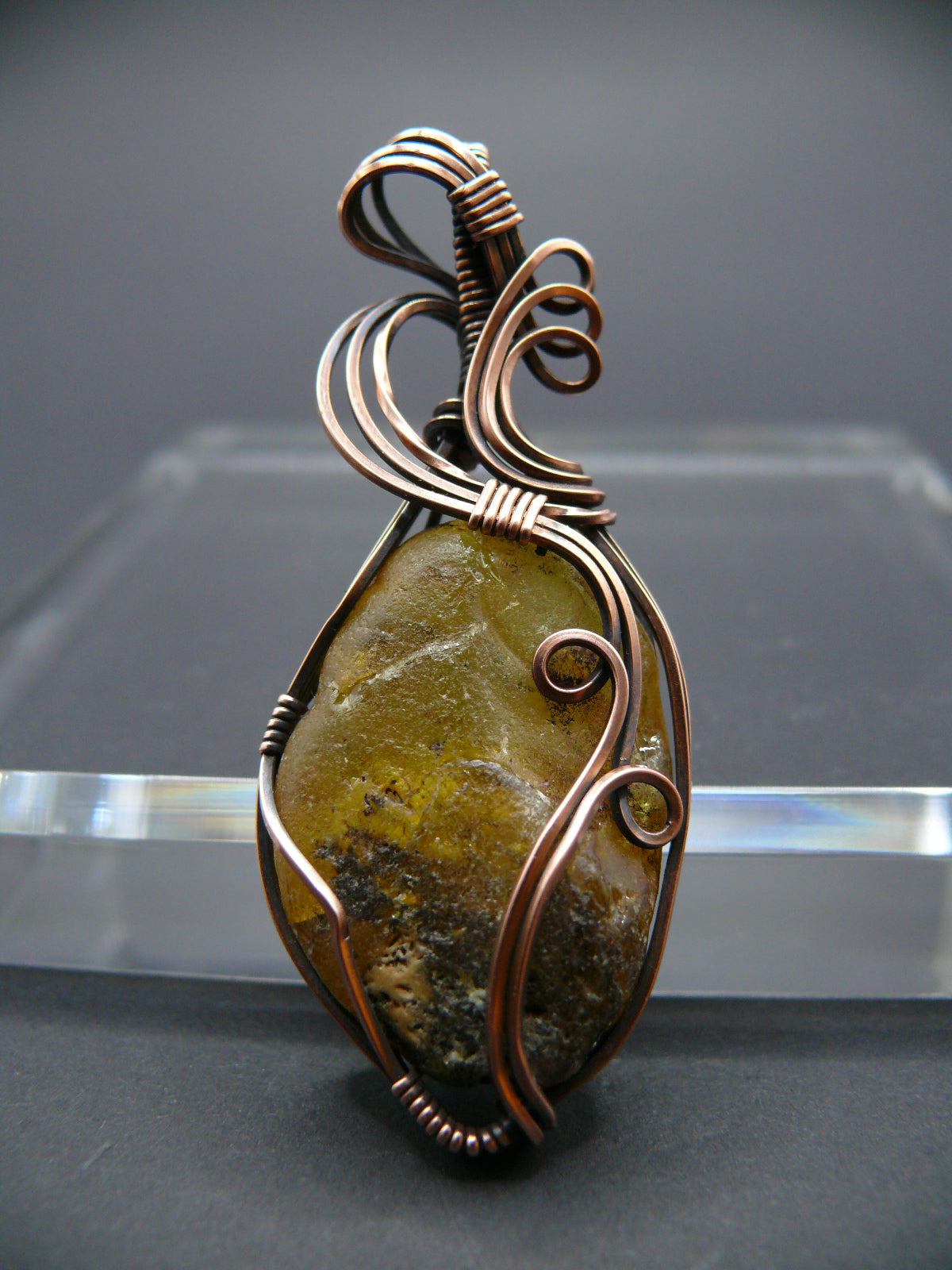 Copper wire wrapped raw Baltic amber pendant