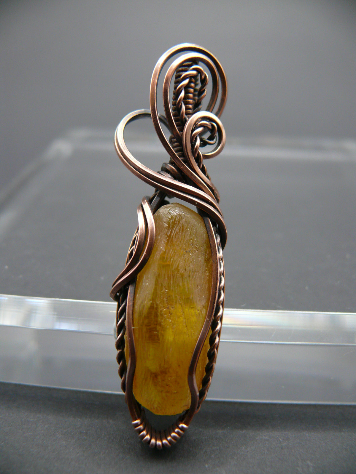 Copper wire wrapped raw Baltic amber pendant