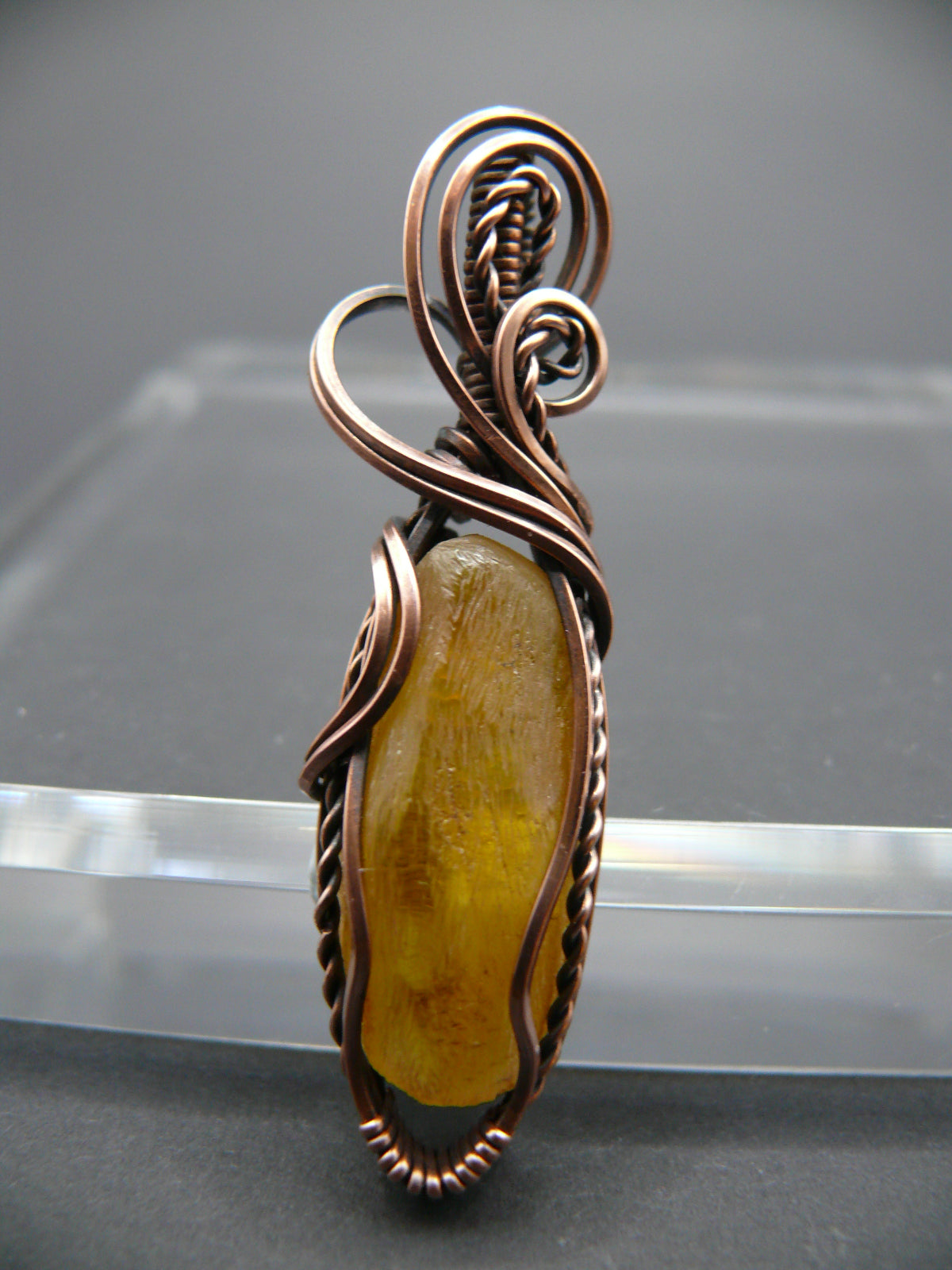 Copper wire wrapped raw Baltic amber pendant