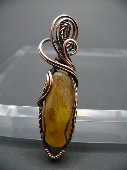 Copper wire wrapped raw Baltic amber pendant