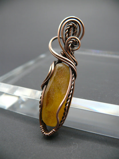 Copper wire wrapped raw Baltic amber pendant