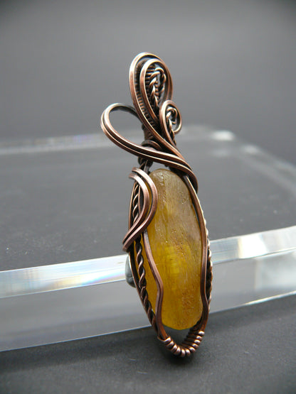 Copper wire wrapped raw Baltic amber pendant