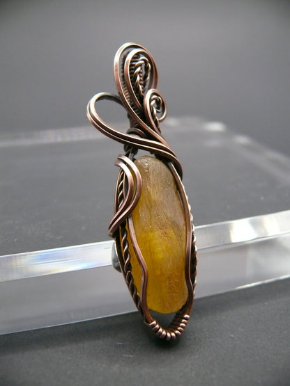 Copper wire wrapped raw Baltic amber pendant