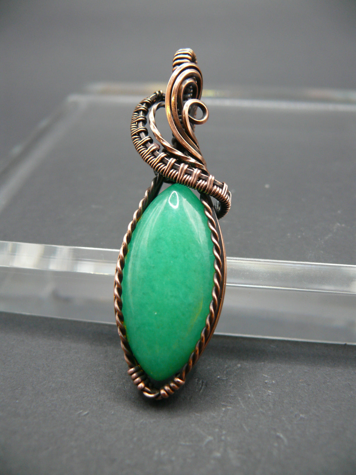 Copper-wrapped Jade gemstone pendant