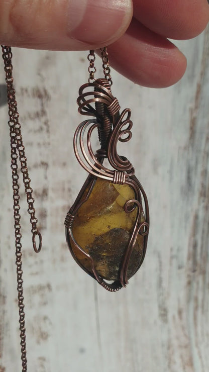 Copper wire wrapped raw Baltic amber pendant