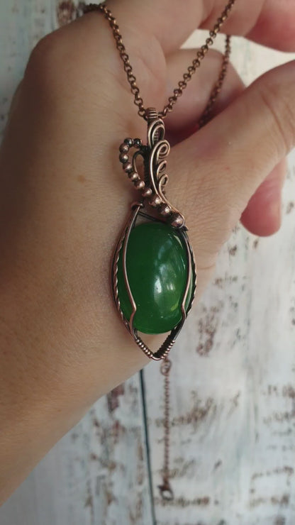 Copper-wrapped jade gemstone pendant