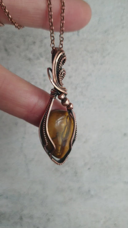 Tiger eye gemstone pendant wrapped in antiqued copper