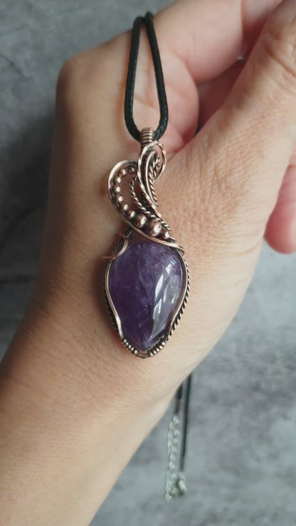 Amethyst gemstone pendant wrapped in antiqued copper